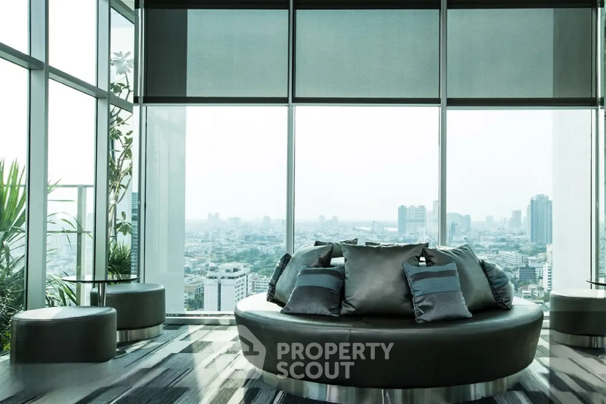 Luxurious high-rise living room with panoramic city views and modern decor.