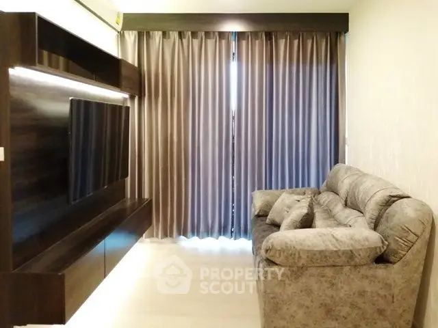 Modern living room with cozy sofa and elegant curtains, perfect for relaxation.