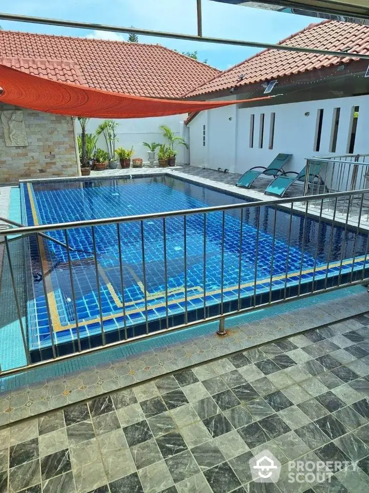 Stunning private pool area with modern design and sun loungers, perfect for relaxation.