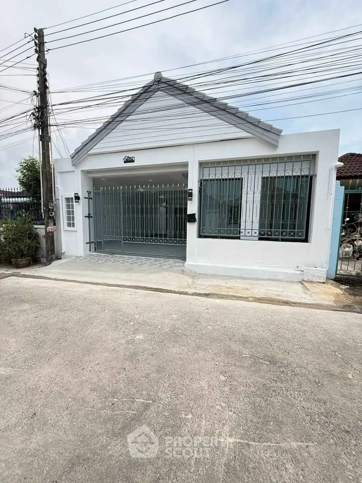 Charming single-story home with gated entrance and modern facade, perfect for family living.