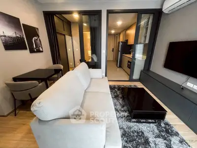 Modern living room with sleek furniture and open kitchen layout