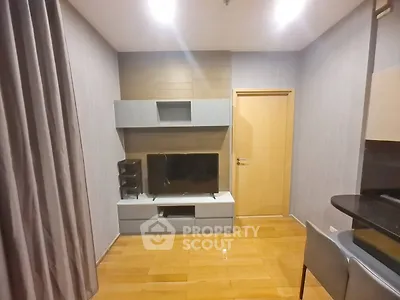 Modern living room with sleek TV unit and wooden flooring