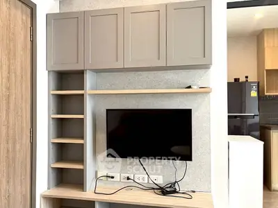 Modern living room with wall-mounted TV and sleek storage cabinets