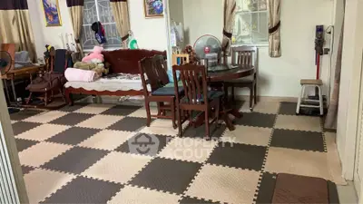 Spacious living room with checkered flooring and elegant wooden dining set