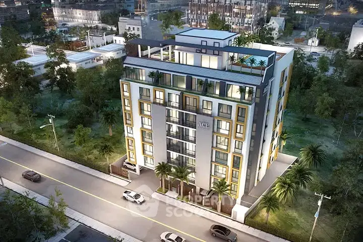 Stunning aerial view of modern apartment building with lush surroundings and rooftop terrace.