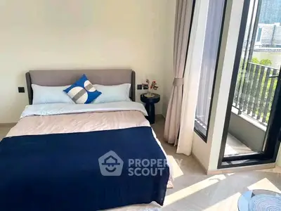 Bright and modern bedroom with balcony access and city view, perfect for urban living.