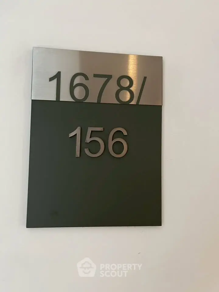 Modern apartment number sign with sleek metallic finish, perfect for contemporary urban living spaces.
