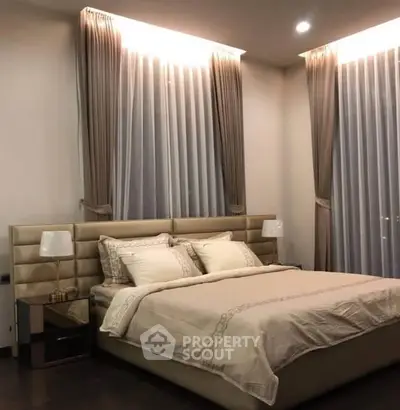 Luxurious bedroom with elegant curtains and modern lighting