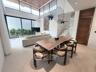 Luxurious modern living room with high ceilings and elegant dining area
