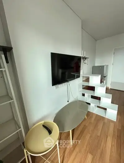 Modern living room with sleek TV setup and stylish shelving unit.