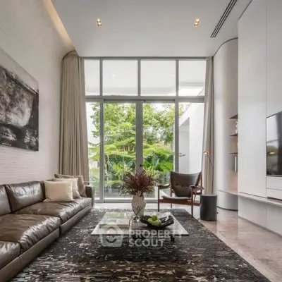 Luxurious modern living room with floor-to-ceiling windows and elegant decor