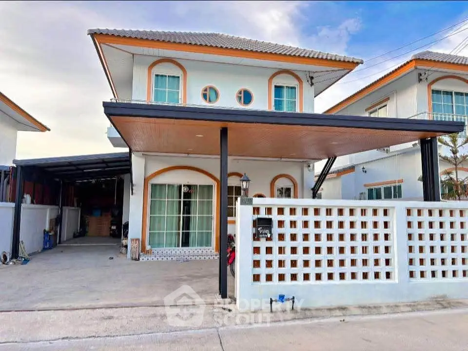 Charming two-story house with carport and modern facade in a serene neighborhood.