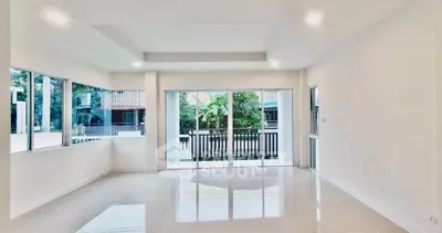 Spacious modern living room with large windows and balcony access