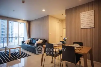Modern living room with stylish decor and dining area in open layout apartment.