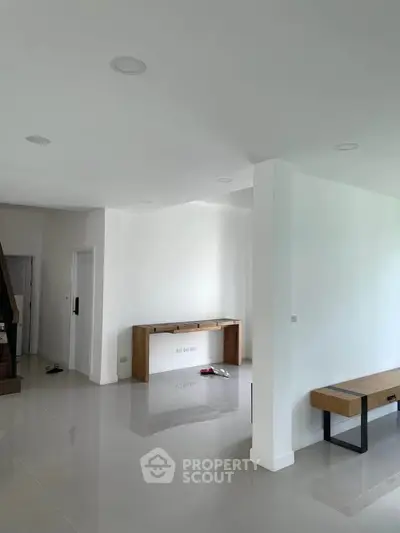 Spacious modern living area with sleek design and minimalist furniture, perfect for contemporary living.