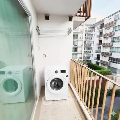 Modern apartment balcony with washing machine and scenic view