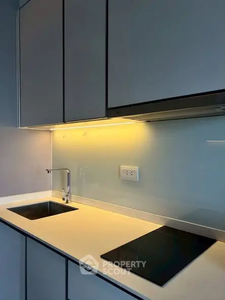 Modern kitchen with sleek cabinetry and built-in stovetop