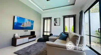 Modern living room with sleek design, large windows, and wall-mounted TV