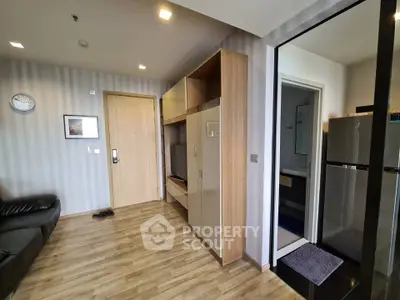 Modern apartment interior with wooden flooring and sleek kitchen area