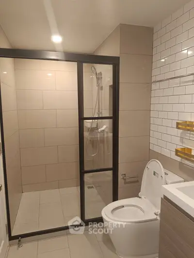 Modern bathroom with glass shower and sleek tile design