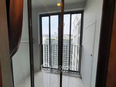 Modern apartment balcony with city view and sleek glass doors