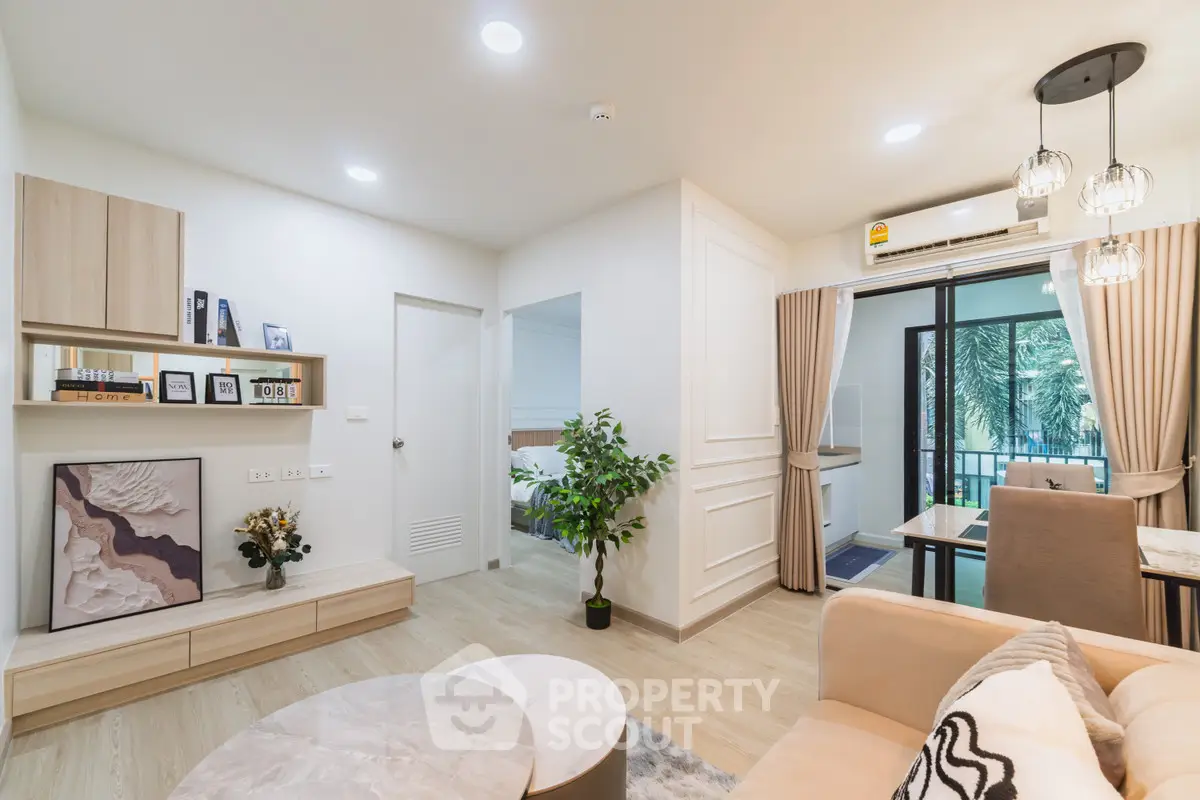 Modern living room with elegant decor and open layout leading to dining area and balcony.