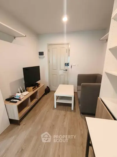 Cozy living room with modern furniture and wooden flooring, perfect for relaxation and entertainment.