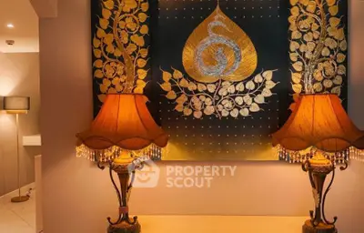 Elegant interior with ornate lamps and decorative wall art in a cozy living space.
