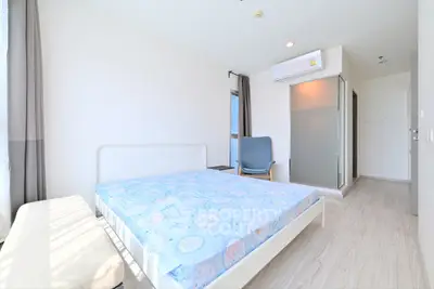 Bright and airy bedroom with modern furnishings and large windows in a stylish apartment.