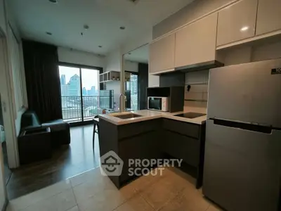 Modern kitchen with sleek appliances and open layout in city apartment with balcony view.