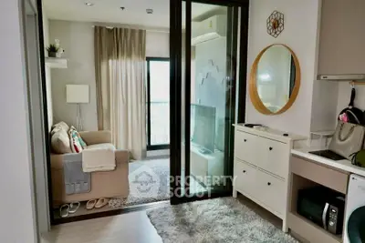 Chic modern living room with cozy sofa, stylish decor, and natural light from balcony.