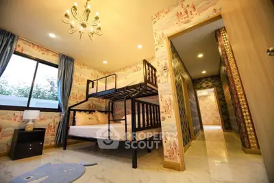 Charming children's bedroom with bunk bed and whimsical wallpaper, perfect for a cozy family home.