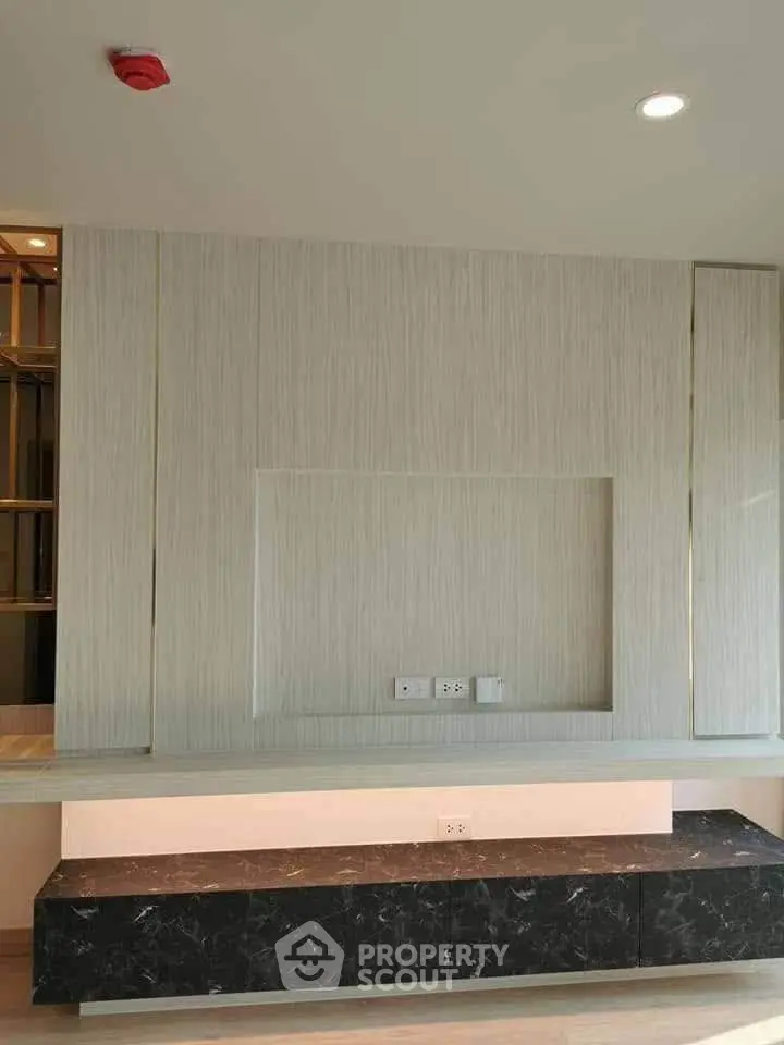 Modern interior wall design with built-in shelving and marble accent in a stylish living room.