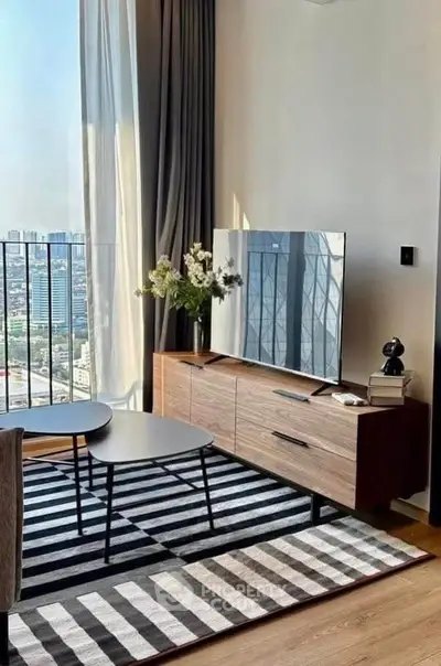 Modern living room with city view, stylish furniture, and large windows for natural light.