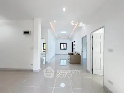 Spacious modern living room with sleek tile flooring and elegant lighting