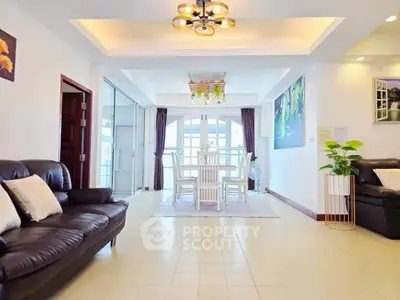 Spacious living room with elegant dining area and modern lighting