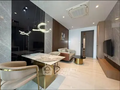 Luxurious modern living room with elegant marble dining table and stylish lighting fixtures.