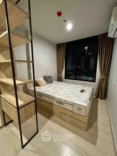 Modern bedroom with large window and stylish shelving unit