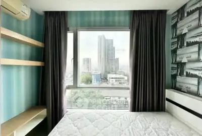 Modern bedroom with city view, featuring stylish wallpaper and ample natural light.