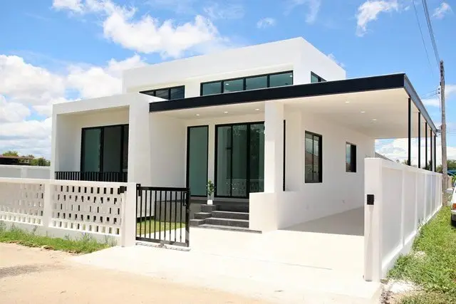 Modern white minimalist house with large windows and sleek design