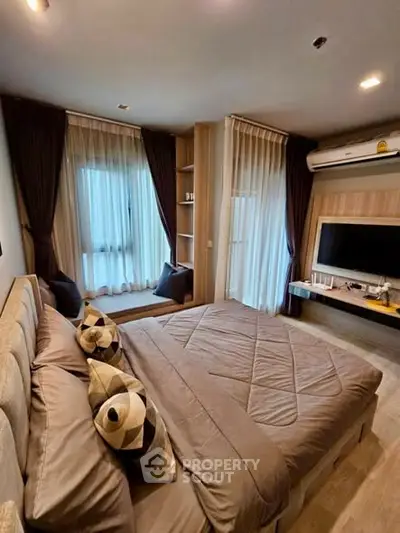 Luxurious bedroom with modern decor and large windows in a stylish apartment.