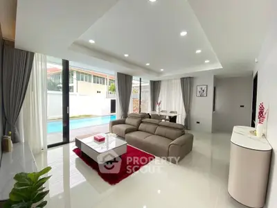 Luxurious modern living room with pool view and elegant decor