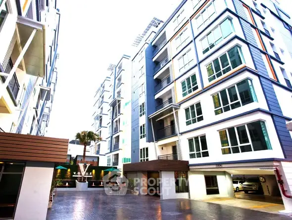 Modern apartment complex with spacious courtyard and contemporary design.