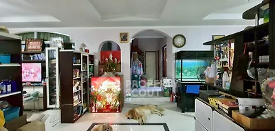 Spacious living room with aquarium and modern decor, featuring a cozy atmosphere and ample storage space.
