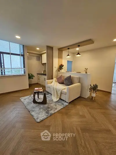 Modern living room with cozy sofa and open kitchen layout
