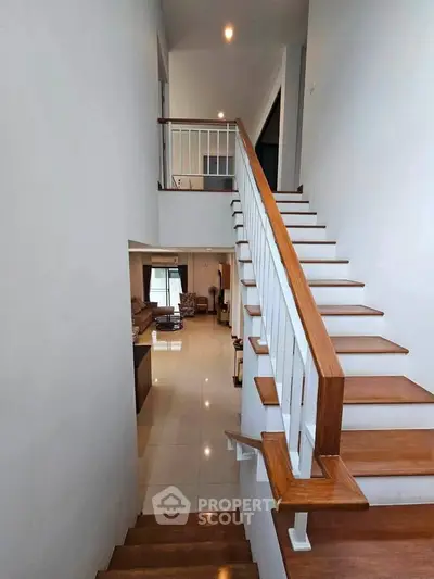 Spacious modern home with elegant wooden staircase and open living area