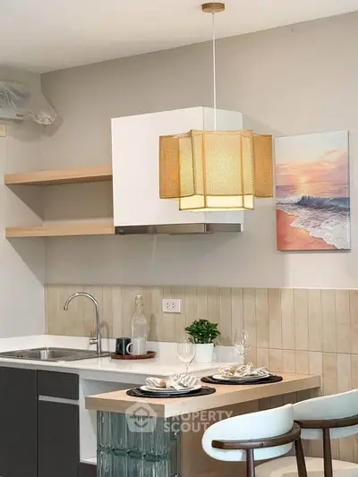 Modern kitchen with stylish pendant light and open shelving, featuring a cozy breakfast bar and elegant decor.
