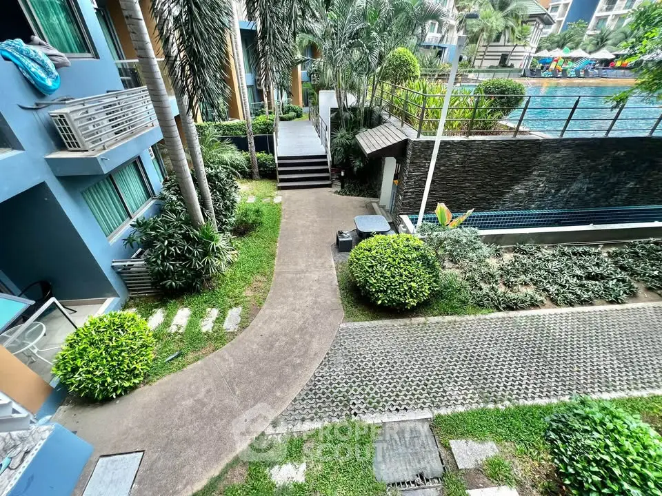 Lush garden view with modern apartment exterior and poolside ambiance.