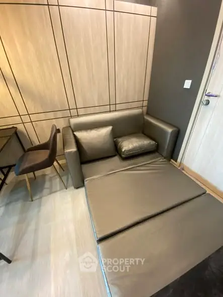 Modern compact living room with convertible sofa bed and stylish decor