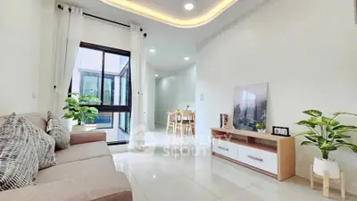 Modern living room with elegant decor and natural light, featuring a cozy sofa and stylish furniture.